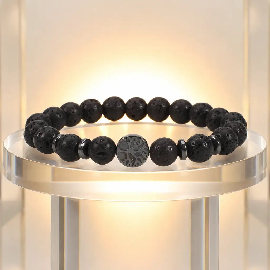 Lava stone bracelet showcased on illuminated stand featuring natural volcanic beads for refined styling.