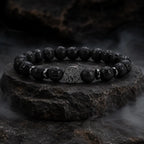 Lava stone bracelet displayed on natural rock with volcanic beads emphasizing strength and modern design.