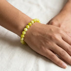 Lemon jade bracelet close up on wrist with glossy beads, natural gemstone jewelry for subtle everyday elegance and comfort
