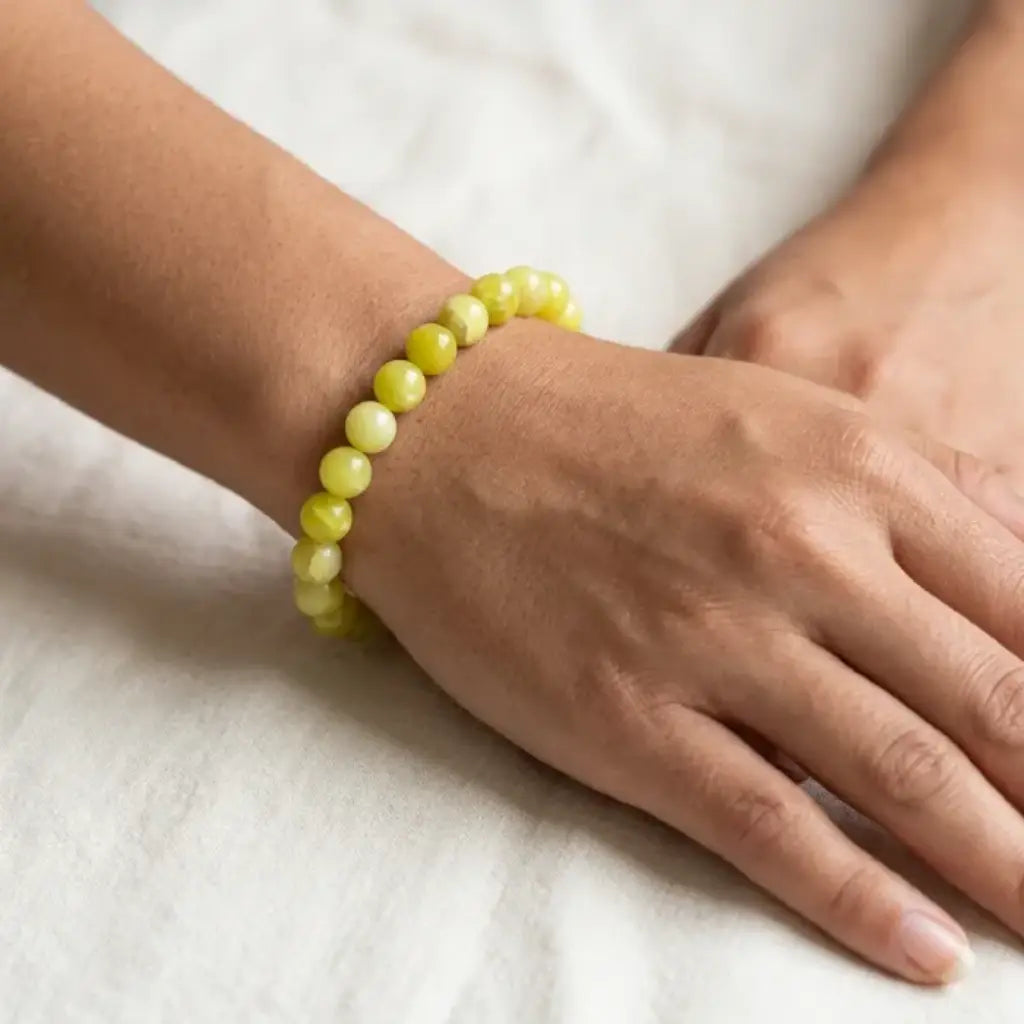 Lemon jade bracelet close up on wrist with glossy beads, natural gemstone jewelry for subtle everyday elegance and comfort
