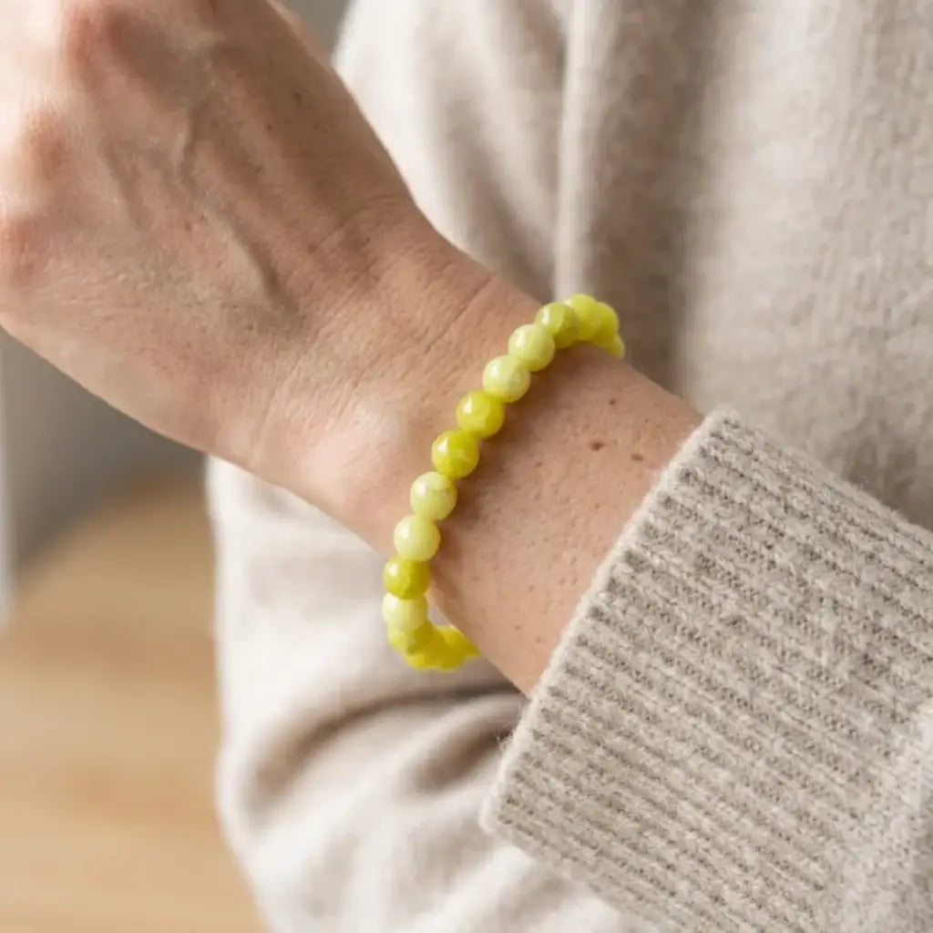 Lemon jade bracelet worn on wrist with soft knit sleeve, natural gemstone accessory for calm everyday styling
