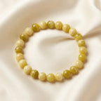 Lemon jade bracelet with striped round beads on ivory silk, elegant gemstone accessory for thoughtful gifting moments
