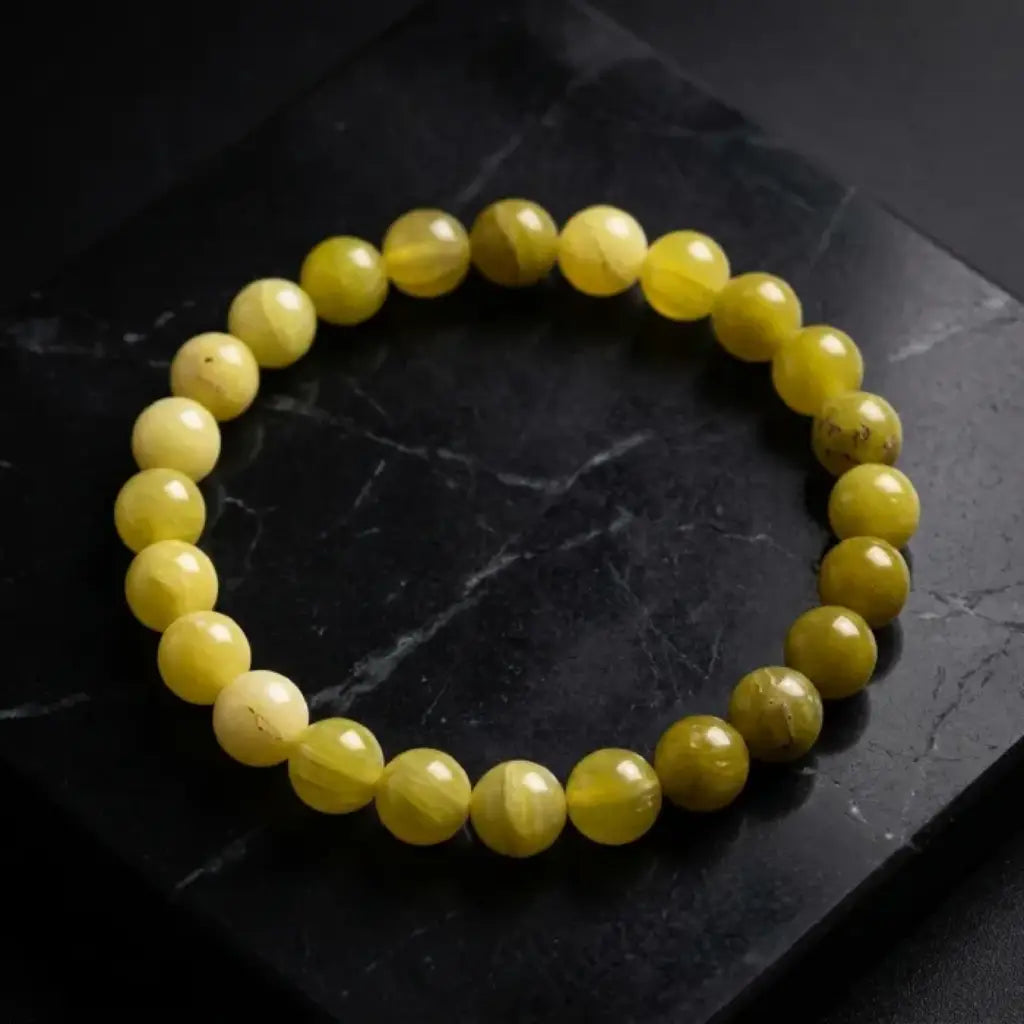 Lemon jade bracelet on dark marble surface with glossy beads, premium gemstone jewelry for bold luxury presentation
