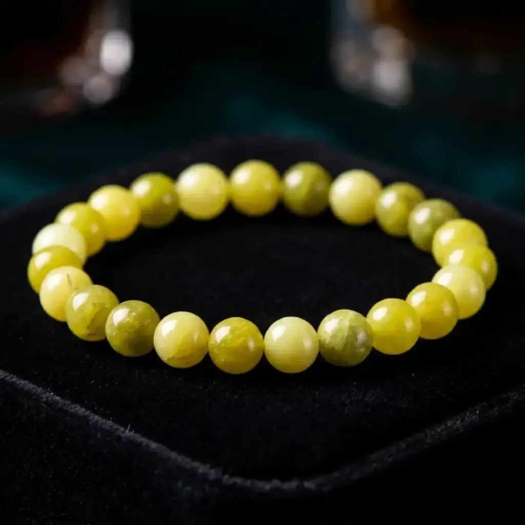 Lemon jade bracelet on black velvet with glossy yellow beads, premium gemstone jewelry for luxe display appeal
