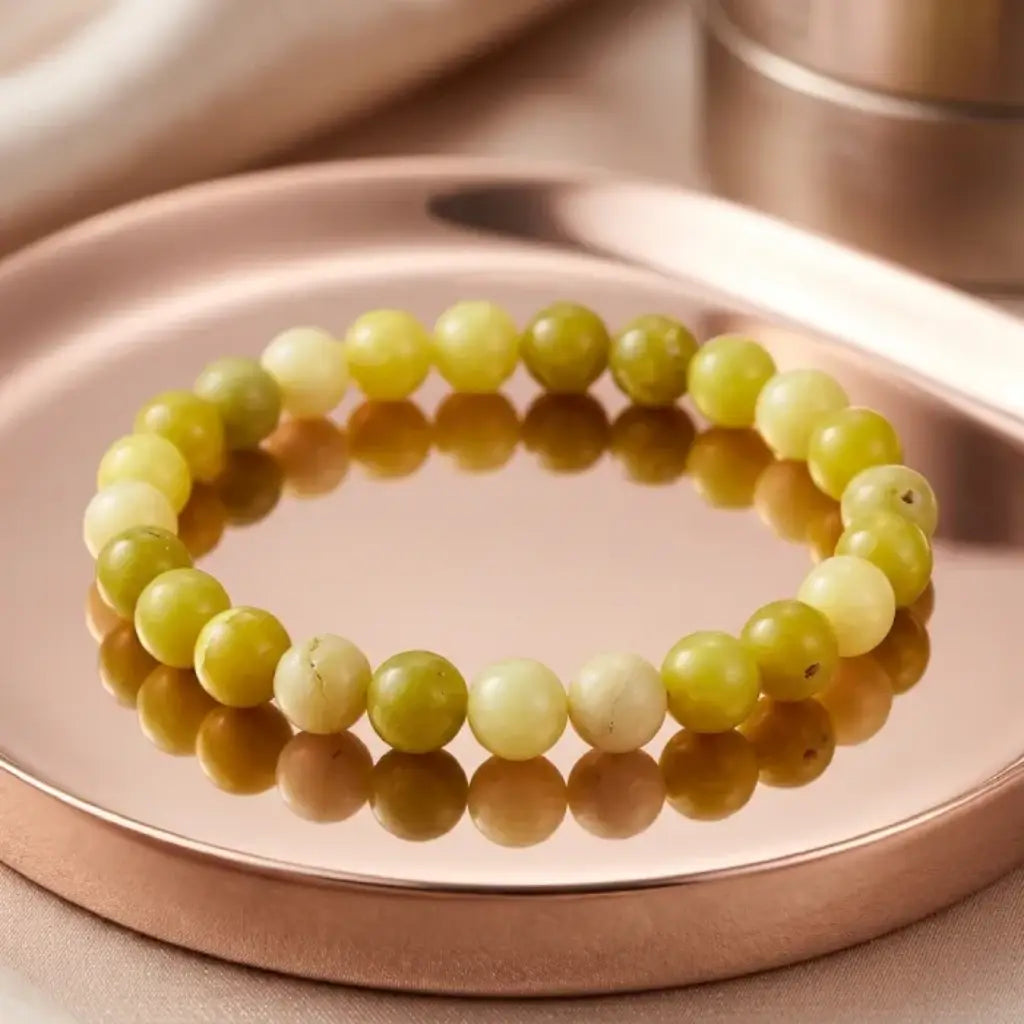 Lemon jade bracelet on reflective tray with polished beads, premium stone jewelry for refined styling display
