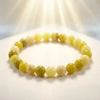 Lemon jade bracelet glowing under soft sunlight with polished beads on fabric, natural gemstone jewelry for radiant style