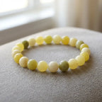 Lemon jade bracelet on soft neutral fabric with glossy beads, calming gemstone jewelry for everyday minimal style
