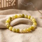 Lemon jade bracelet on textured fabric with warm tones, premium gemstone jewelry for cozy natural styling presentation
