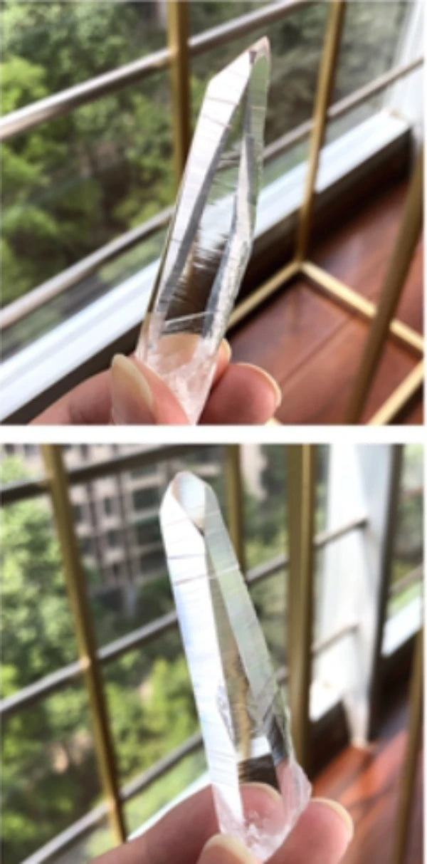 Lemurian long quartz crystal point with transparent body and distinct growth lines, an eye-catching specimen for collectors and crystal enthusiasts.