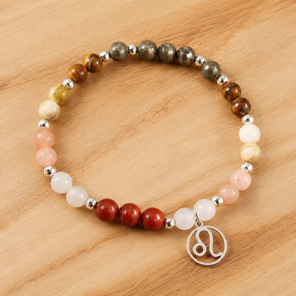 Leo crystal jewelry bracelet featuring natural gemstones and zodiac charm displayed on warm wooden surface background.