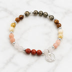 Leo crystal jewelry bracelet with natural healing gemstones and zodiac charm displayed on elegant marble background.