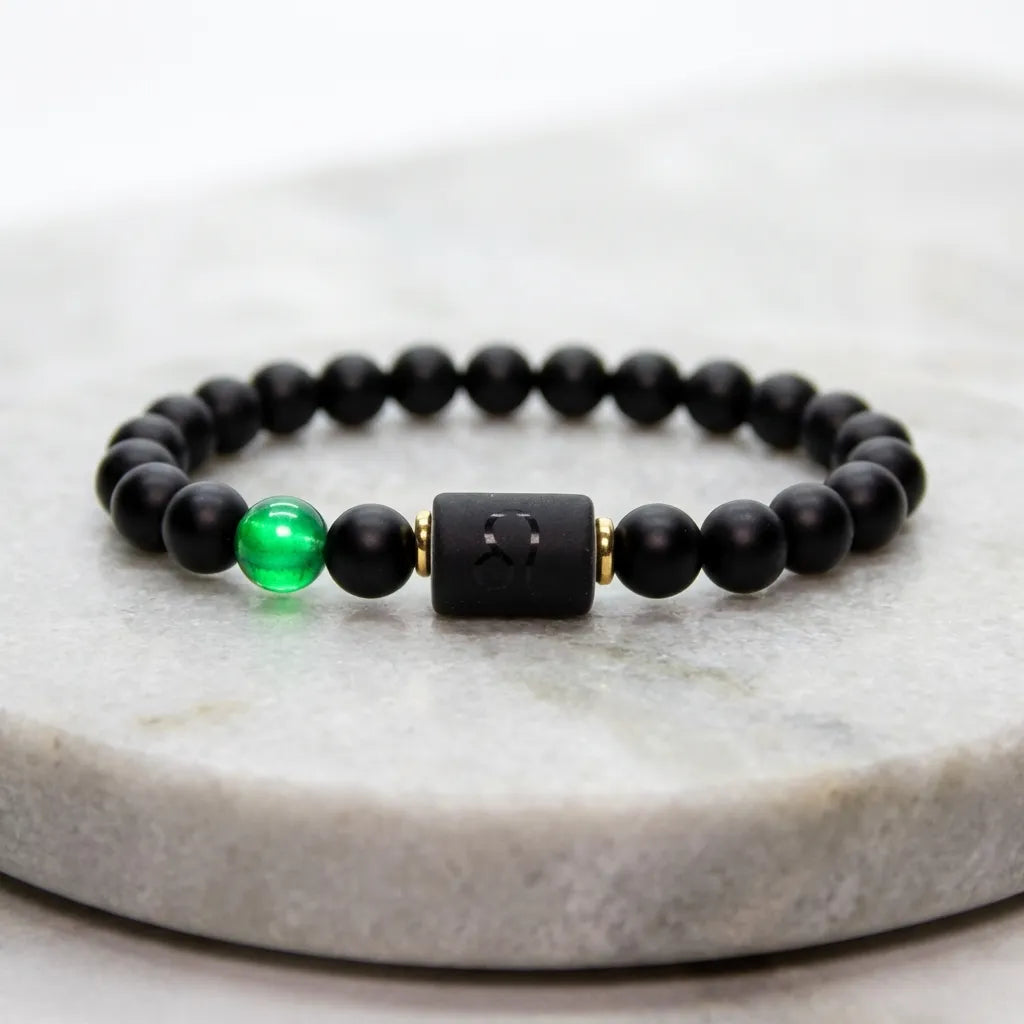 Leo zodiac bracelet with matte black beads and green accent stone on marble, premium zodiac jewelry for confident styl