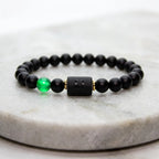 Leo zodiac bracelet with matte black beads and green accent stone on marble, premium zodiac jewelry for confident styl