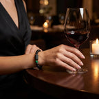 Leo zodiac bracelet worn by woman with black beads and green stone, elegant jewelry for confident sophisticated lifestyle