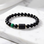 Leo zodiac bracelet with black beads and vibrant green gemstone, modern astrology accessory for bold personality and style
