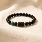 Leo zodiac bracelet with matte black beads and green stone, timeless astrology jewelry symbolizing strength and confidence
