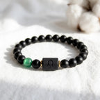 Leo zodiac bracelet with polished black beads and green stone, luxury astrology jewelry symbolizing strength and personal power