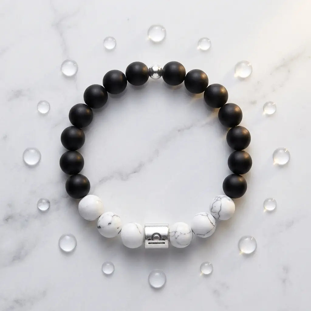 Black and white beaded bracelet on a marble surface with clear crystals.