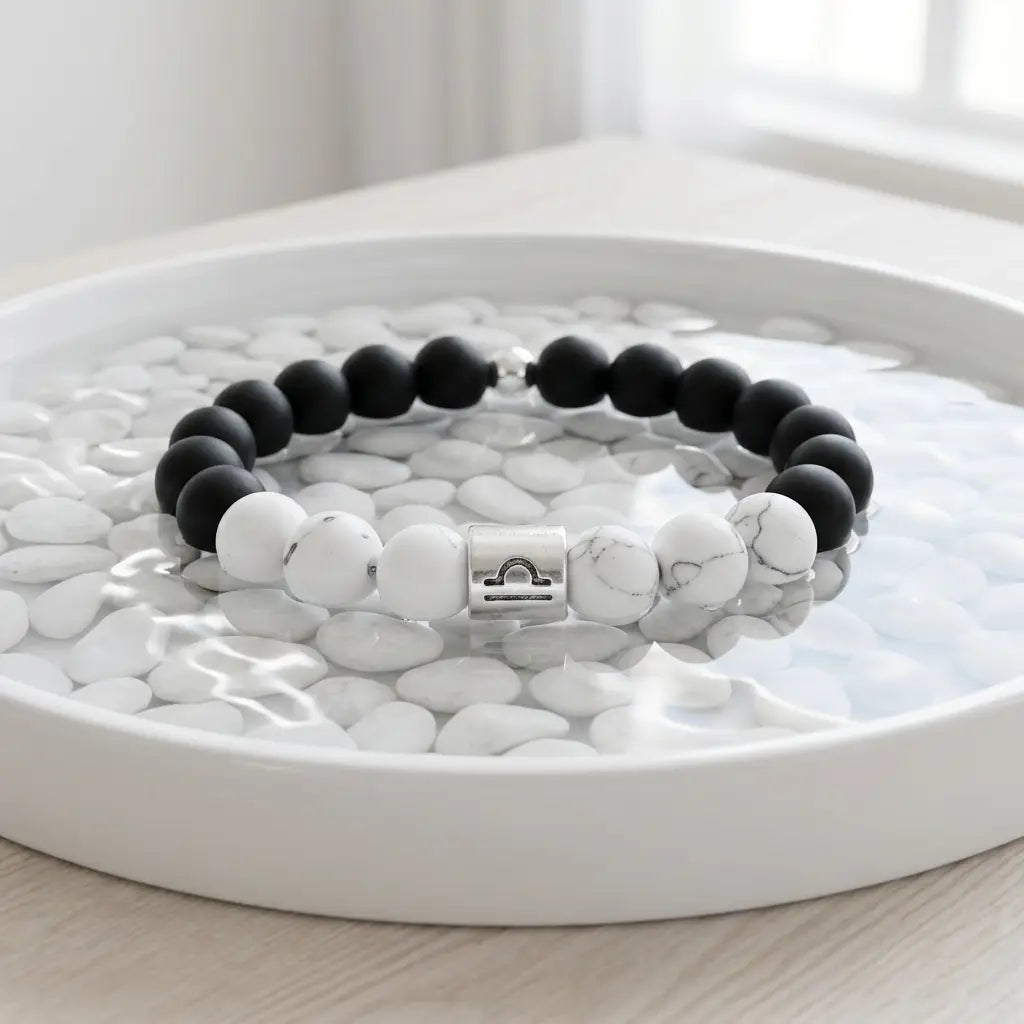 Black and white beaded bracelet on a white pebble surface