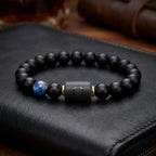 Libra zodiac bracelet with matte black beads, blue accent stone, and engraved center bead on black leather.