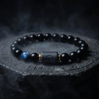 Libra zodiac bracelet with matte black beads, blue accent stone, and engraved center bead on clean white background