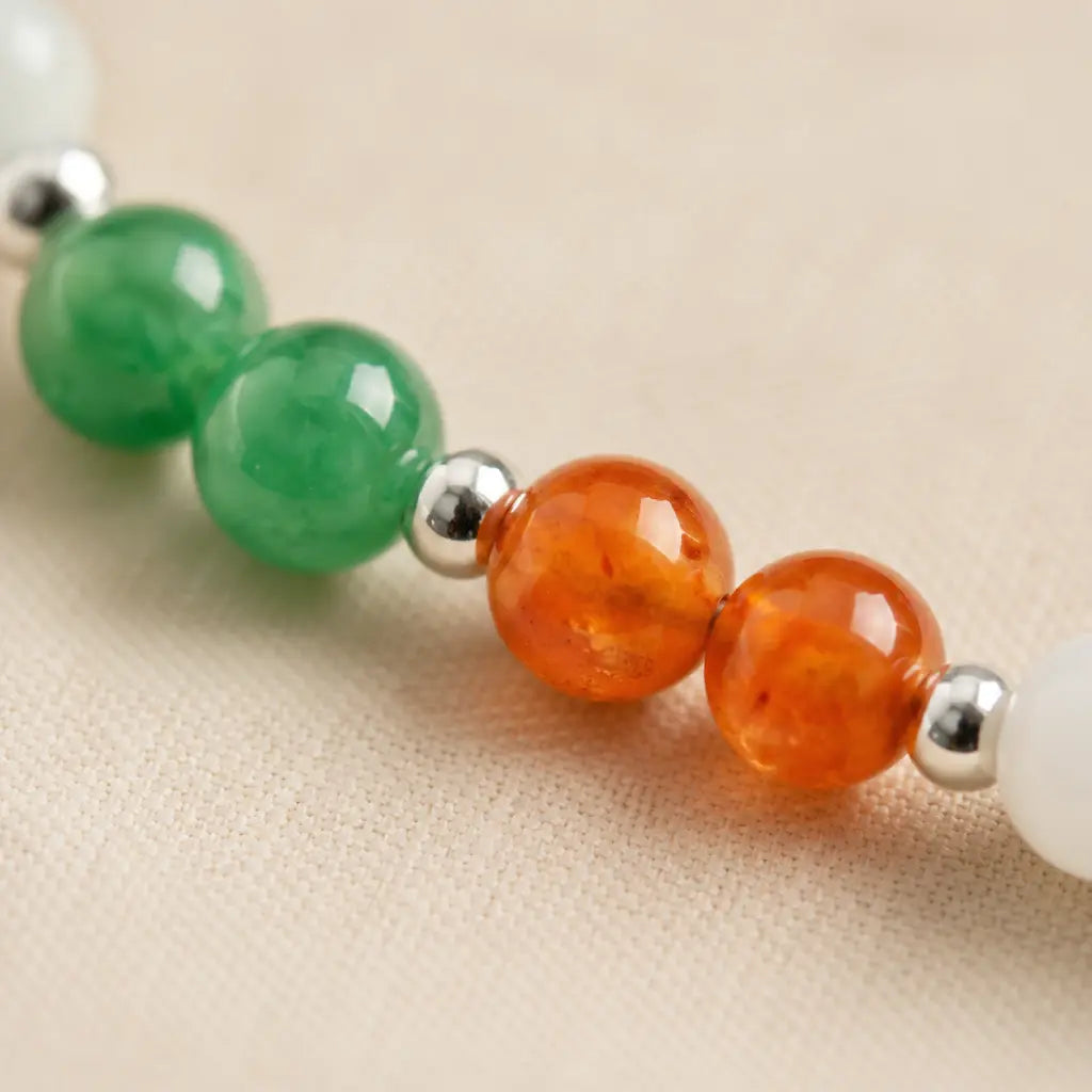 Libra zodiac Jewelry close-up with vibrant carnelian and green gemstone beads creating elegant astrology-inspired charm
