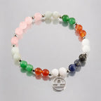 Libra zodiac Jewelry displayed on reflective surface highlighting vibrant gemstone bracelet and silver zodiac charm