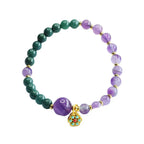 Lotus bracelet featuring purple and green crystal beads with elegant healing jewelry inspired design
