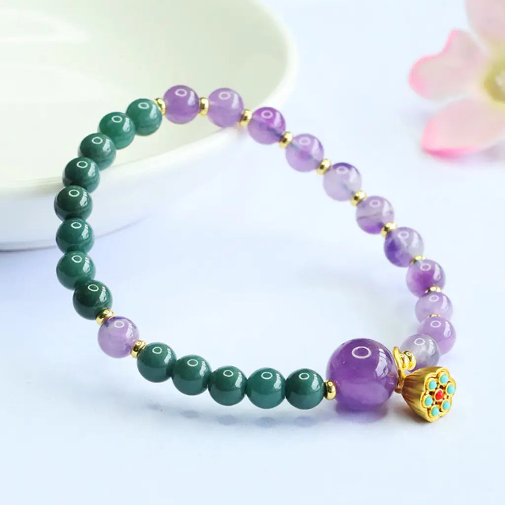 Lotus bracelet with purple and green gemstone beads featuring crystal jewelry details for elegant mindful wear