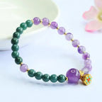 Lotus bracelet with purple and green gemstone beads featuring crystal jewelry details for elegant mindful wear