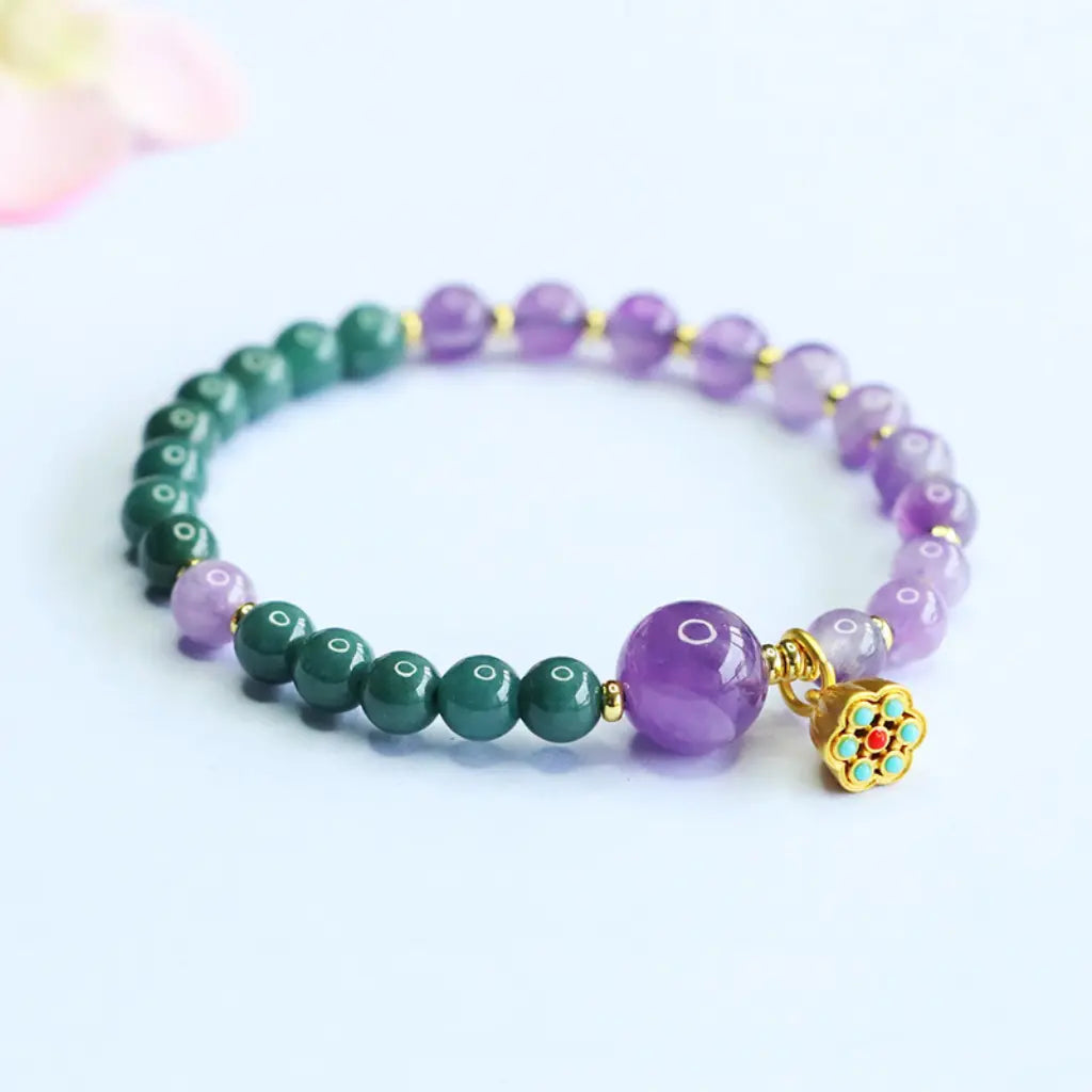 Lotus bracelet with polished gemstone beads and lotus charm designed for peaceful energy and style