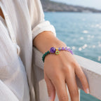 Lotus bracelet with healing crystal beads worn near ocean scenery for relaxed mindful style appeal