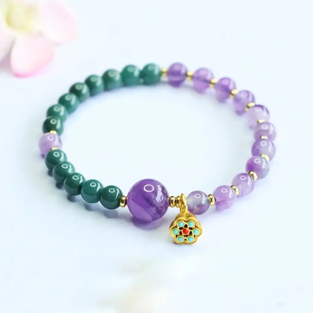 Lotus bracelet showcasing healing crystal gemstones and delicate charm details for everyday wellness fashion