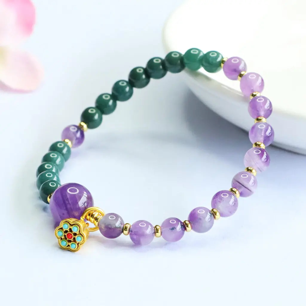 Lotus bracelet with amethyst crystal beads and gold lotus charm creating stylish spiritual jewelry appeal