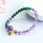 Lotus bracelet with amethyst crystal beads and gold lotus charm creating stylish spiritual jewelry appeal