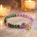 Lotus bracelet with amethyst beads and green gemstones in warm candlelight for calming spiritual style