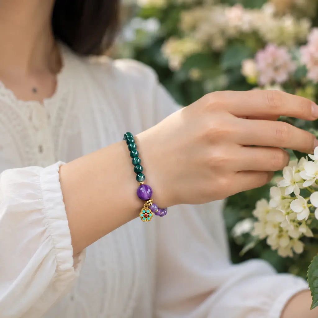 Lotus bracelet worn with floral background featuring healing crystal beads for stylish mindful living