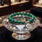 Lotus charm tigereye elegant bracelet displayed on crystal stand with green gemstone healing appeal