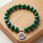 Lotus charm tigereye gemstone bracelet with green crystal beads and wellness-inspired meditation design