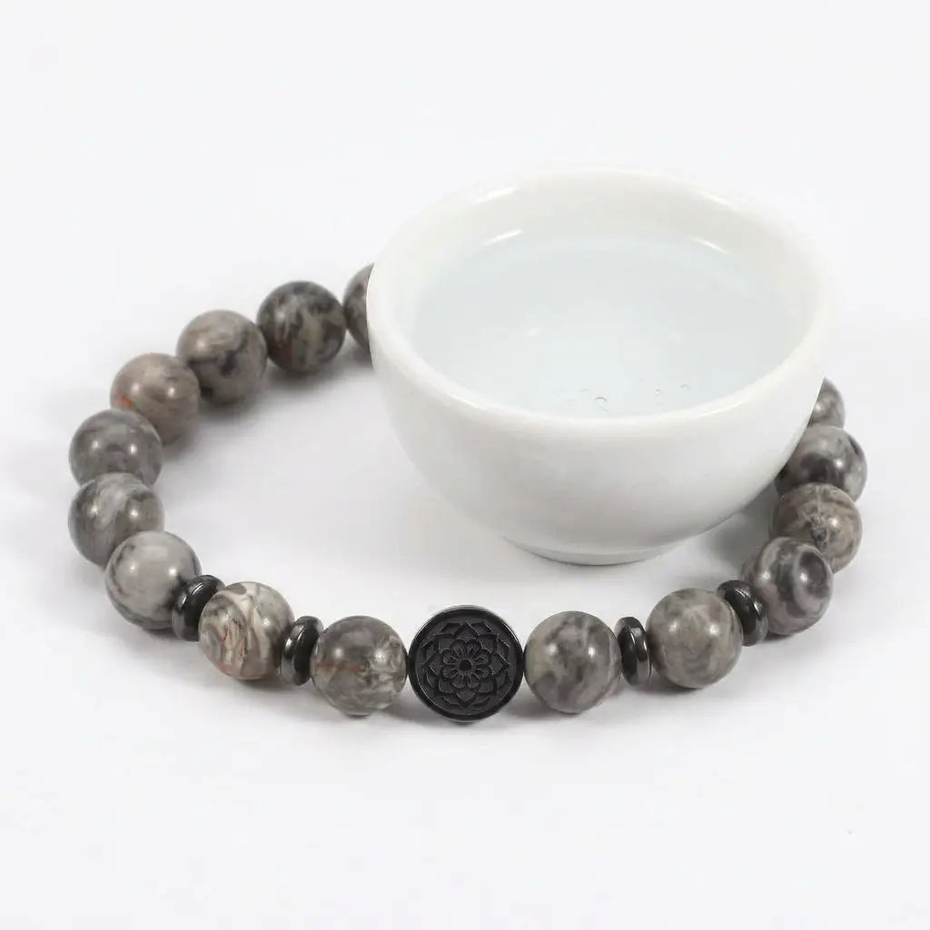 map jasper bracelet around white bowl with gray stone beads, calming gemstone jewelry for peaceful rituals daily