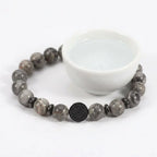 map jasper bracelet around white bowl with gray stone beads, calming gemstone jewelry for peaceful rituals daily