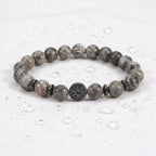 map jasper bracelet on white cloth with water drops, gray gemstone beads for fresh grounding energy and calm focus