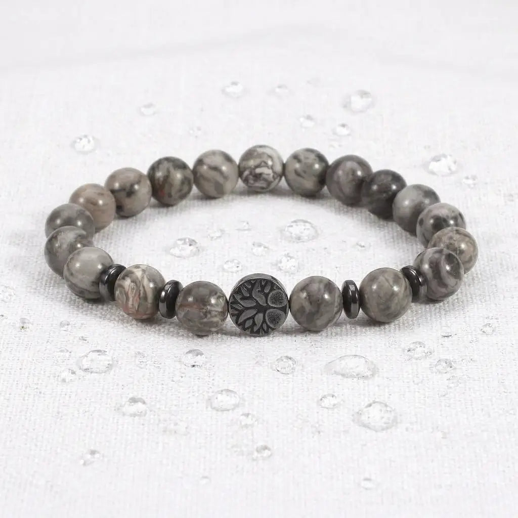 map jasper bracelet on white cloth with water drops, gray gemstone beads for fresh grounding energy and calm focus