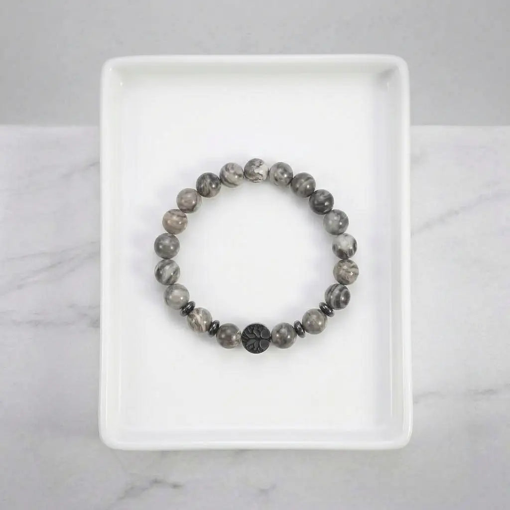 map jasper bracelet centered on white tray with gray beads and black accent, clean minimalist jewelry for modern style