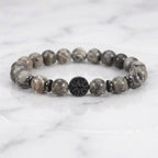 map jasper bracelet on white marble with glossy gray beads and black accent charm for clean modern styling today