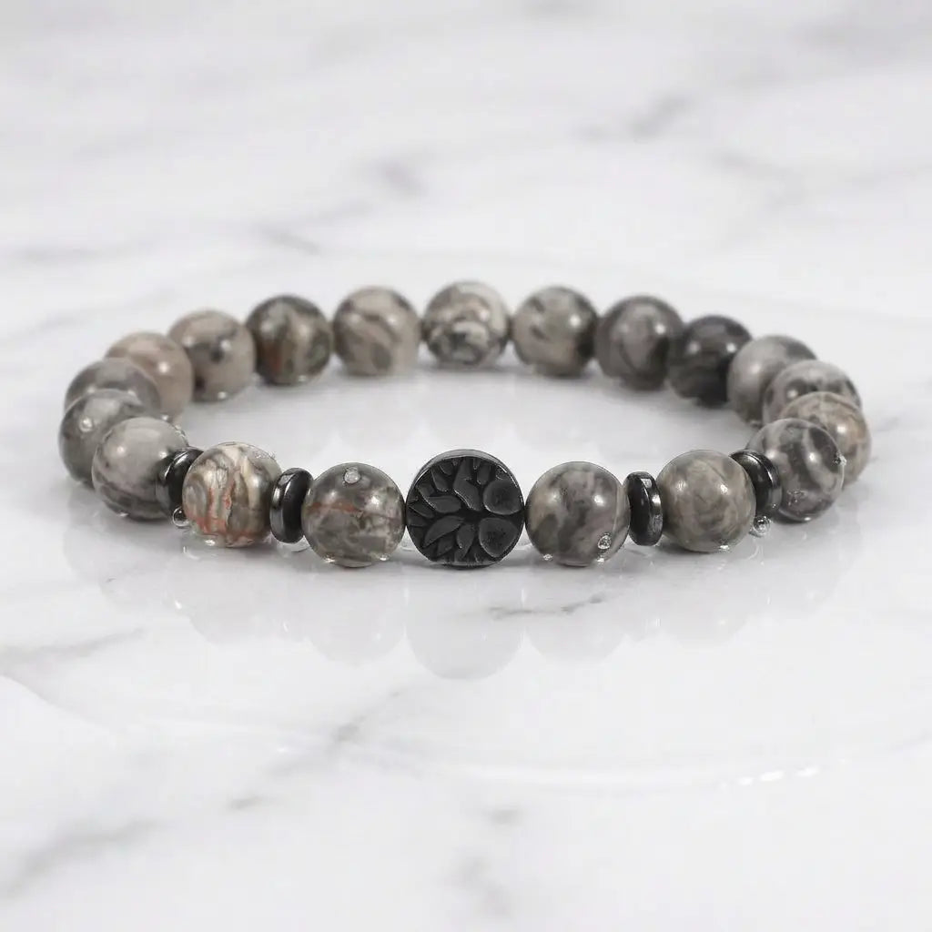 map jasper bracelet on white marble with glossy gray beads and black accent charm for clean modern styling today