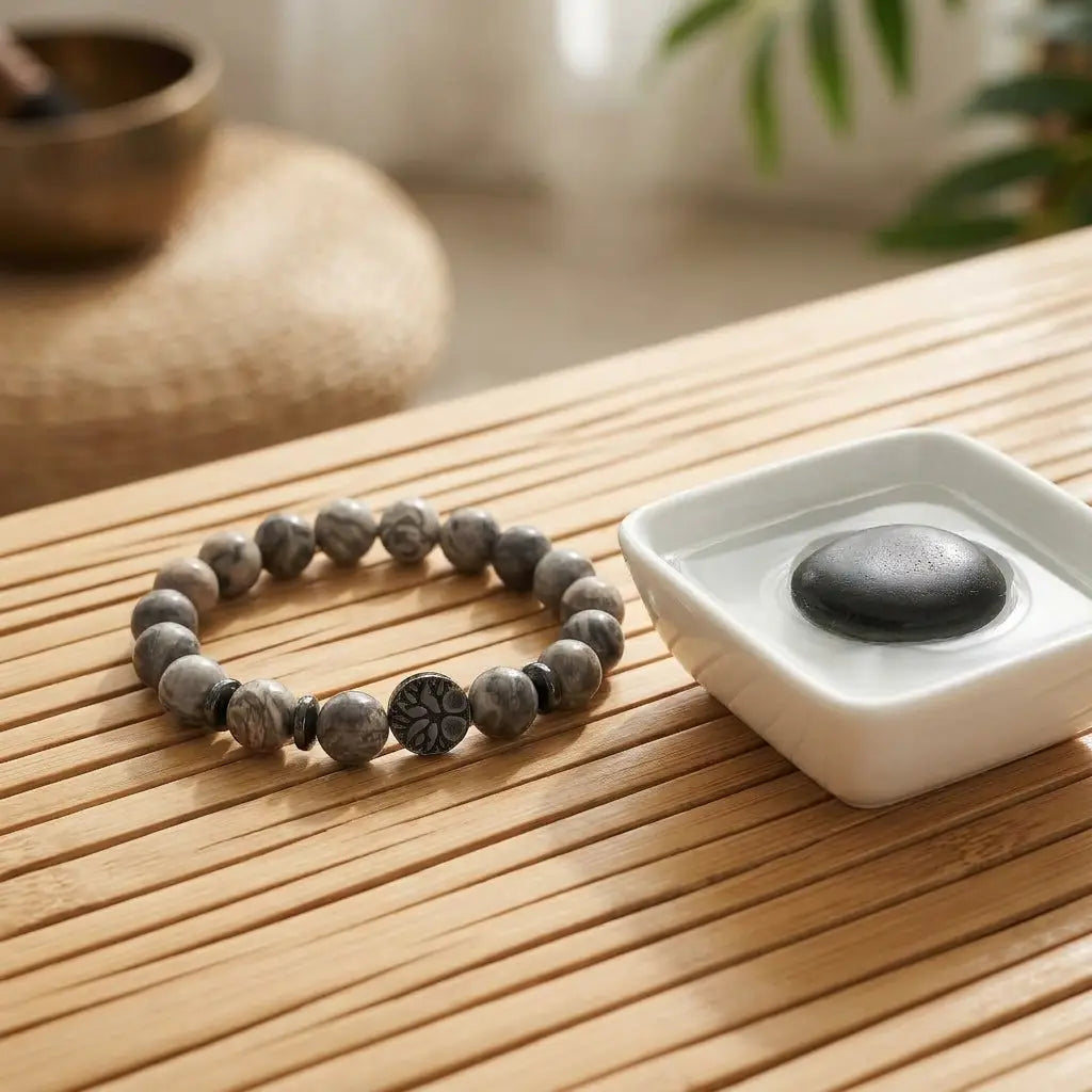 map jasper bracelet on wooden spa surface beside water bowl, natural stone beads for calm lifestyle and daily balance