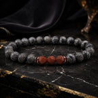 Map stone jasper bracelet with polished gray round beads and red faceted stones on black marble for luxe focus