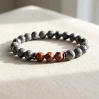 Map stone jasper bracelet on soft cream fabric with gray beads and red accents for minimalist wellness style now
