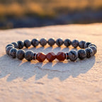 Map stone jasper bracelet displayed at sunset with gray marbled beads and red crystal accents for radiant energy